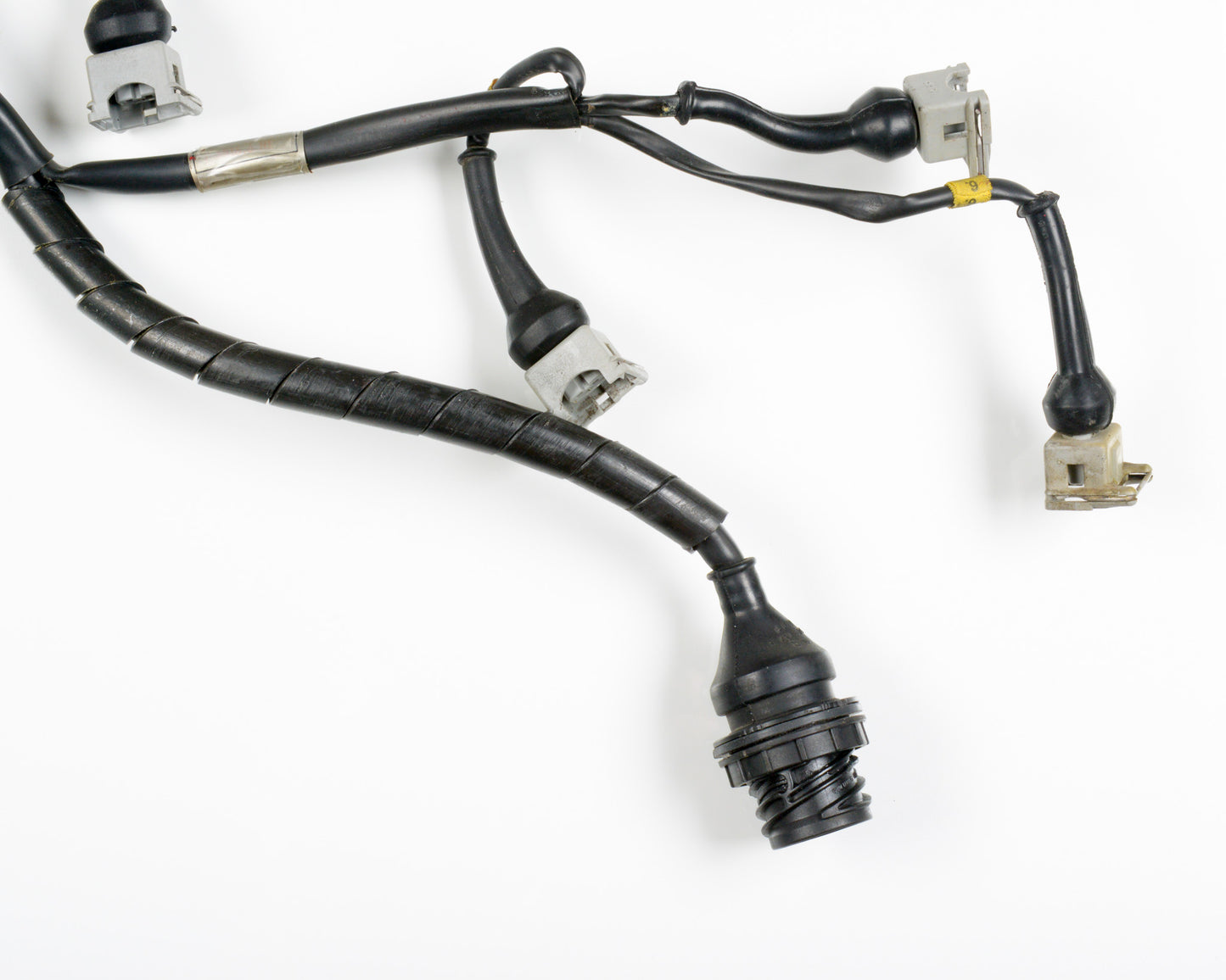 A black automotive wiring harness with multiple connectors and a braided protective sleeve, photographed on a white background.