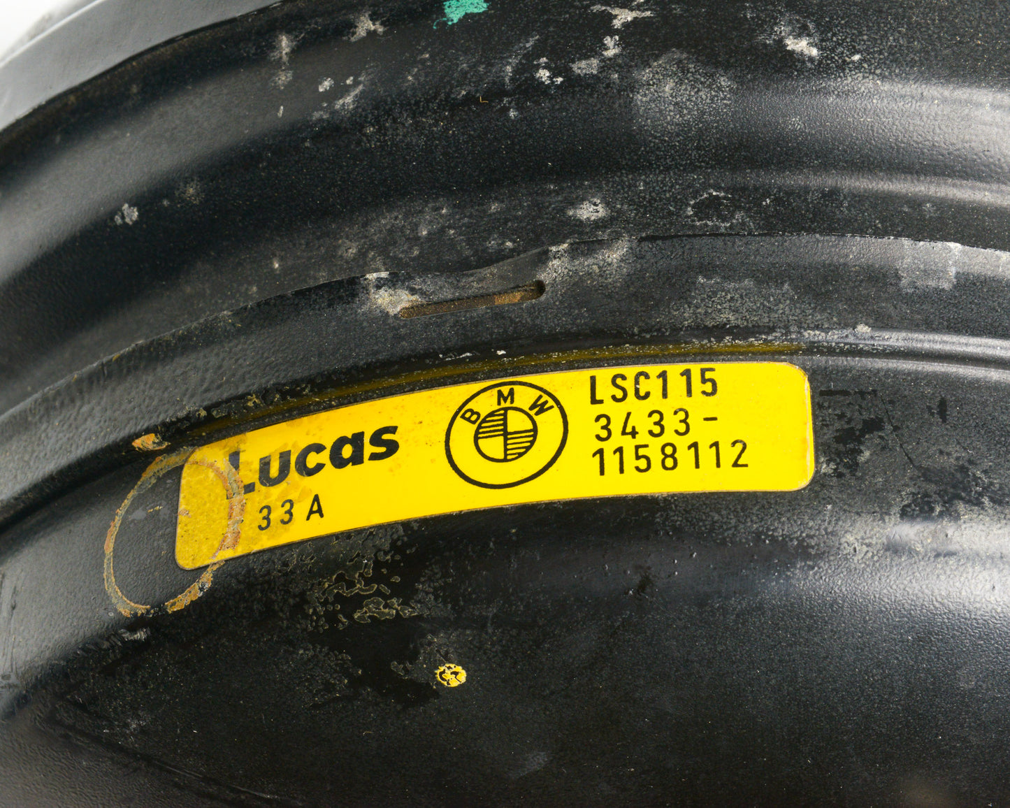 Yellow Lucas label on a black surface with visible wear.