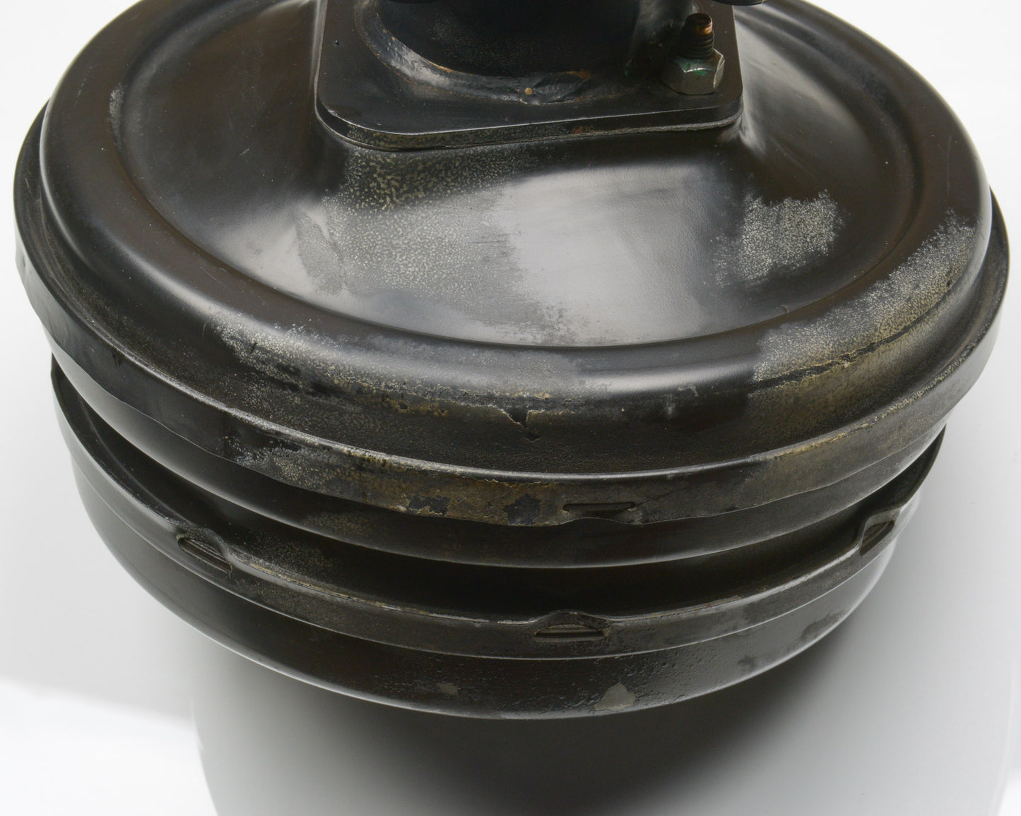 Close-up of a black mechanical component on a white background