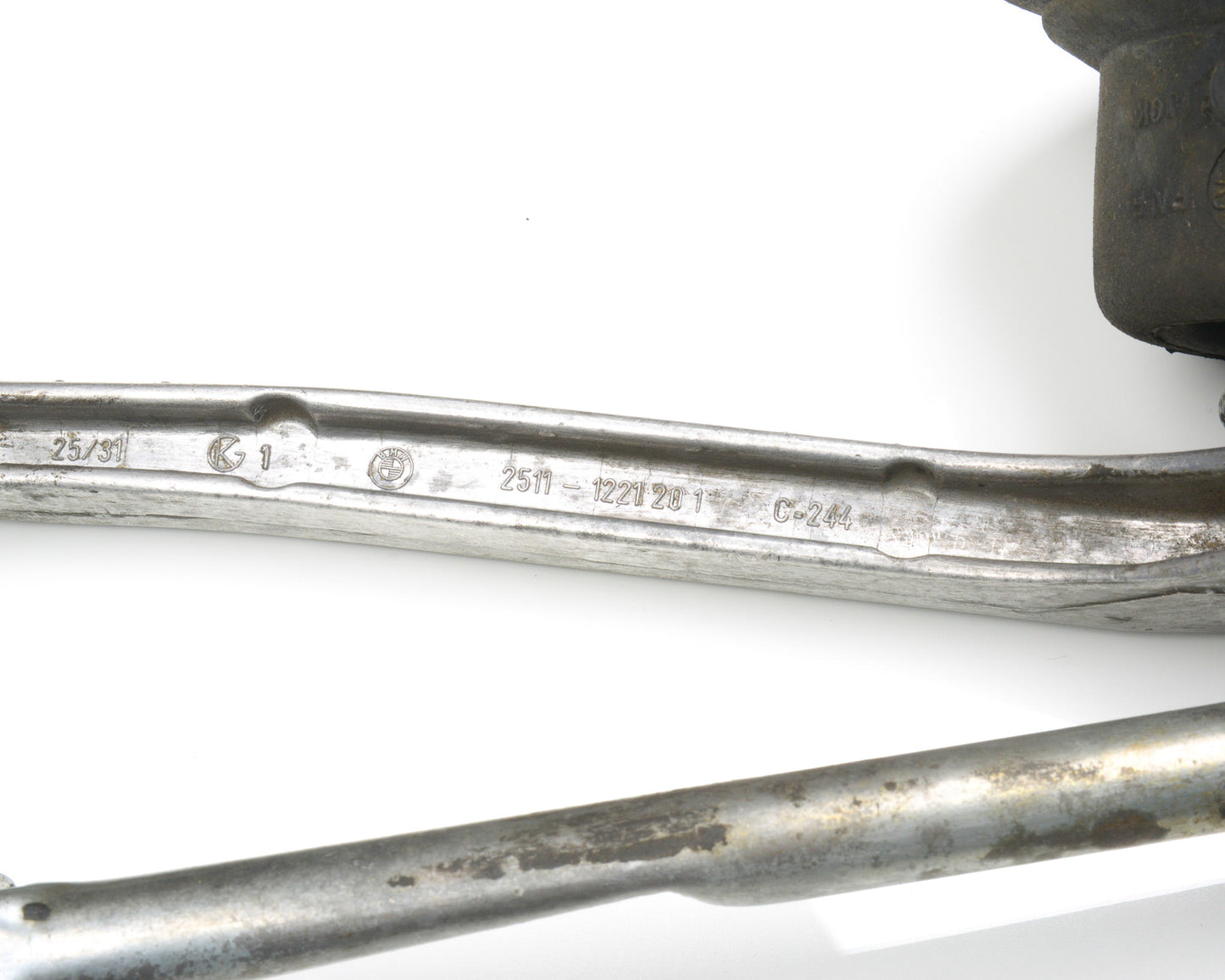 Close-up of metal components with visible branding on a white background