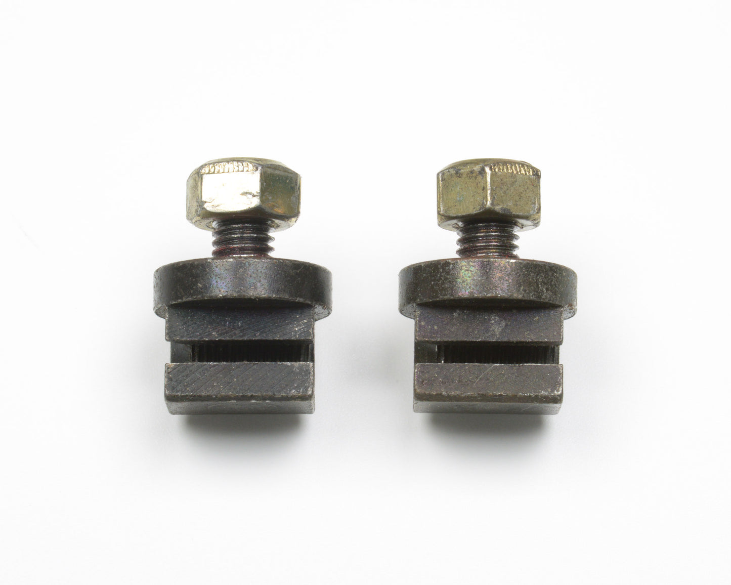 Two metal clamps with bolts on a white background