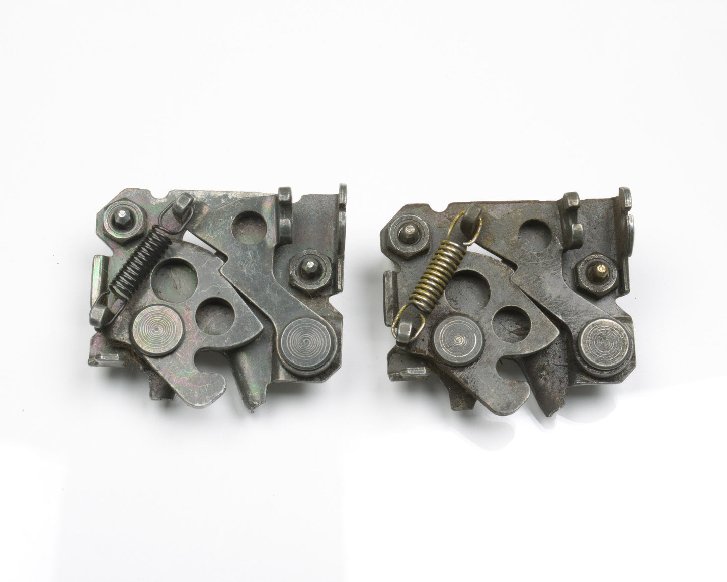 Two metallic mechanical components on a white background