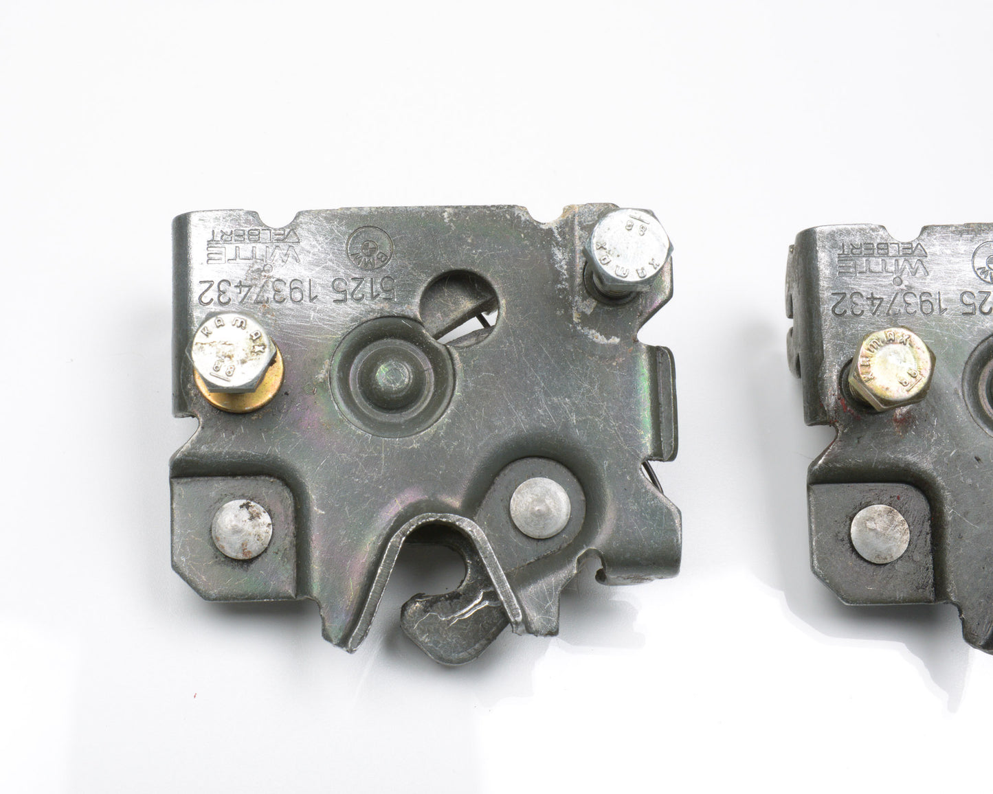 Two metal connectors with screws on a white background