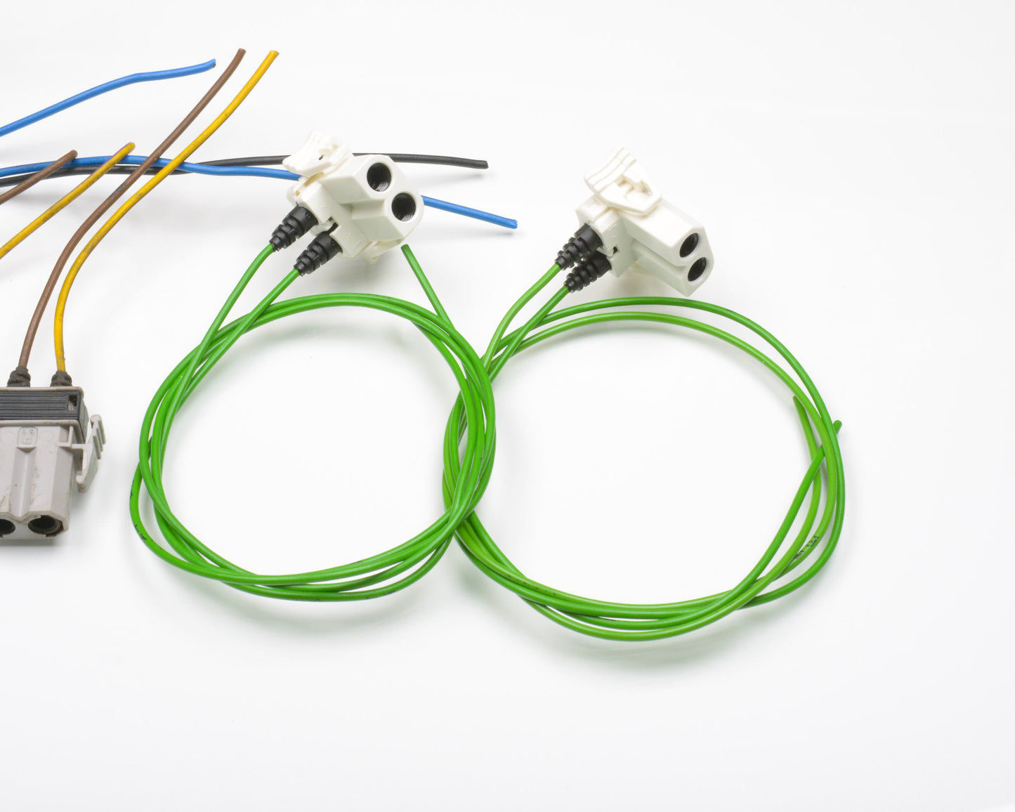Two sets of green wiring with connectors on a white background
