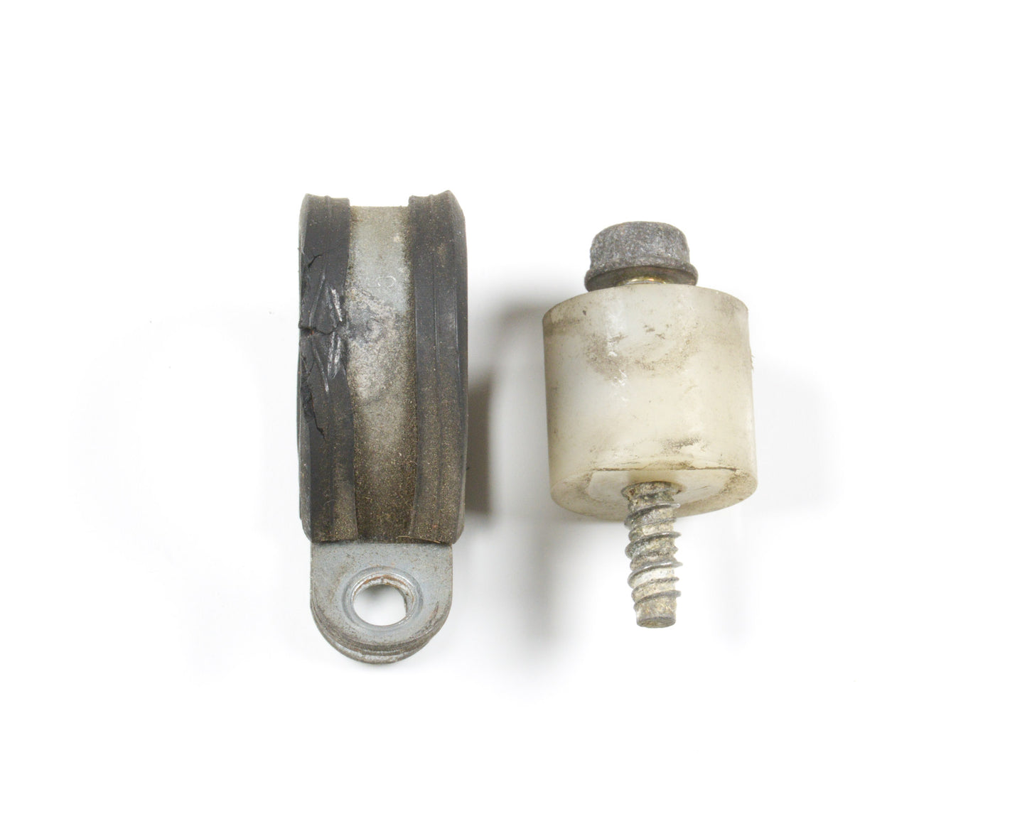 A pair of used mechanical bushings, one dark gray and one off-white, shown on a plain white background.