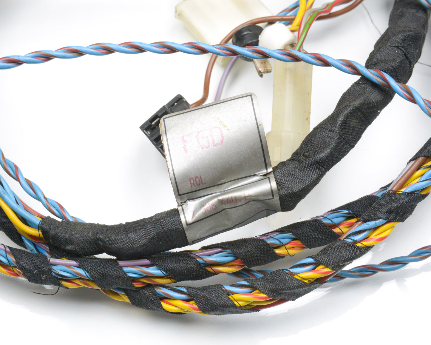 Close-up of electronic wiring with multicolored cables on a white background