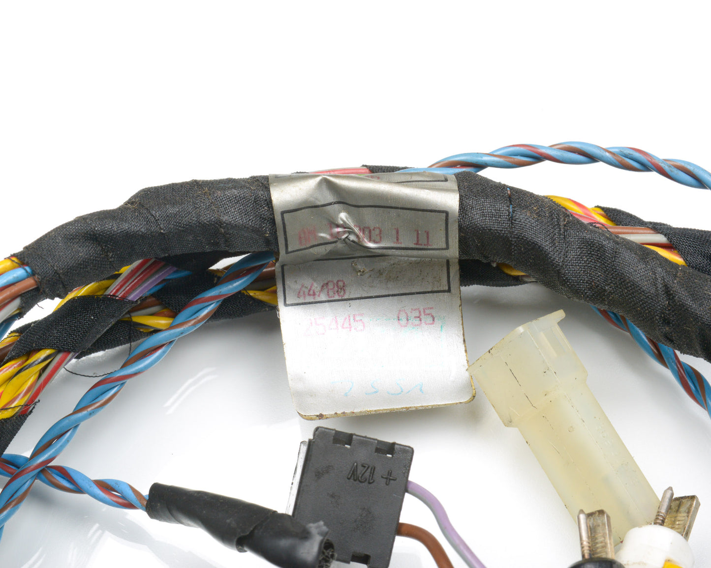 Close-up of electrical wiring with a label on a white background