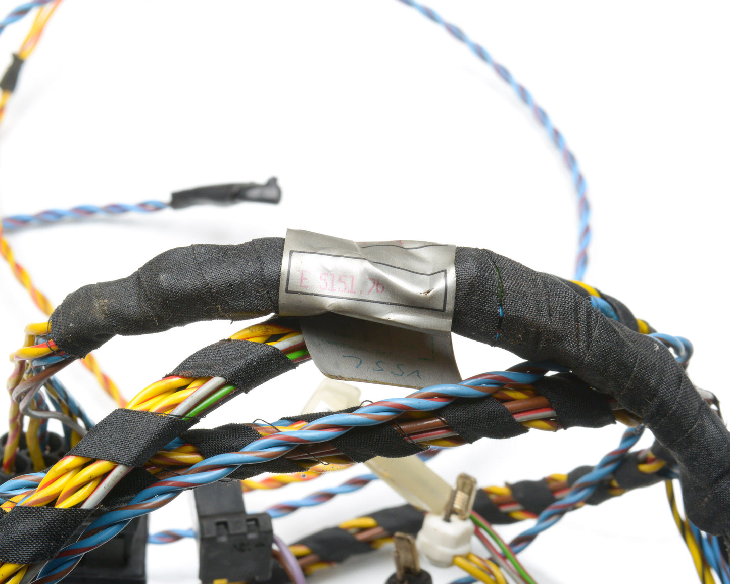 Close-up of a bundle of wires with a metal connector on a white background