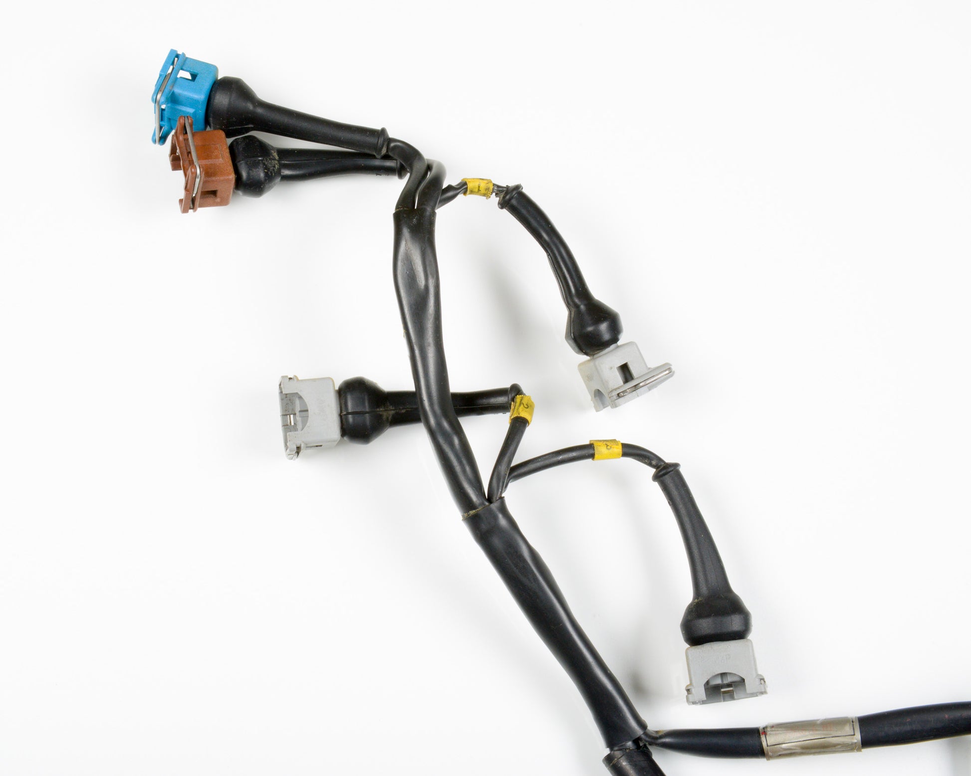 A black automotive wiring harness with various multi-pin connector plugs in blue, brown, silver, and white, shown on a clean white background.