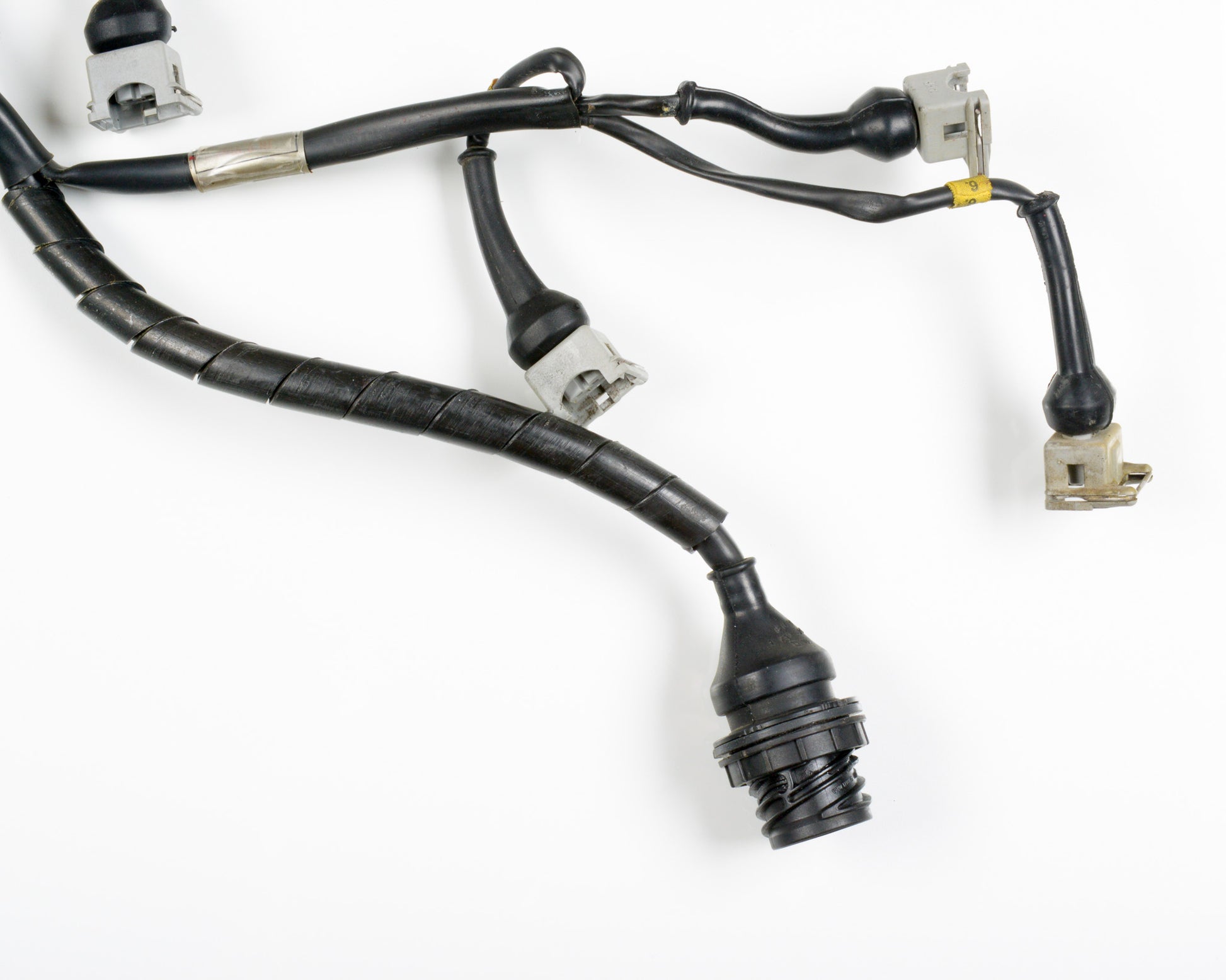 A black automotive wiring harness with multiple connectors and a braided protective sleeve, photographed on a white background.