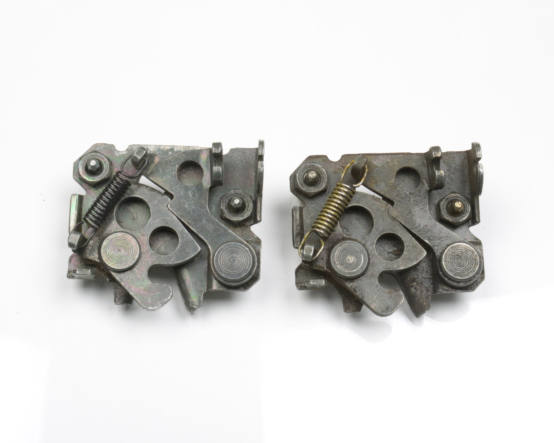 Two metallic mechanical components on a white background